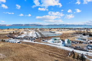 Birds eye view of property with a water and mountain view