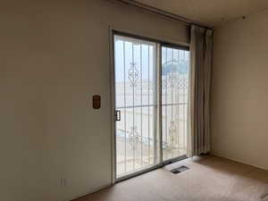 Doorway to outside from the smaller bedroom.