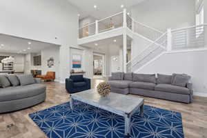 Living room with wood-type flooring and a high ceiling