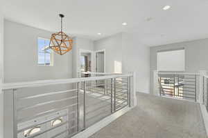 Hallway featuring carpet flooring and plenty of natural light