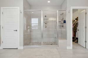 Bathroom with tile patterned flooring and walk in shower