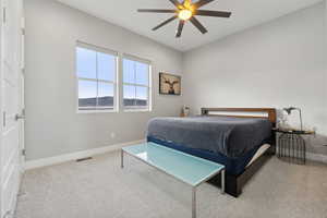 Carpeted bedroom featuring ceiling fan