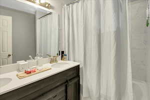 Bathroom featuring vanity and shower / bath combo