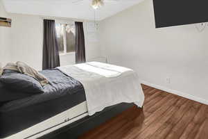 Bedroom featuring ceiling fan and wood-type flooring