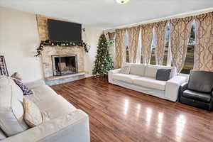 Living room featuring a fireplace and wood-type flooring