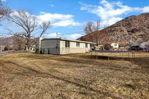 View of yard with a mountain view, a trampoline, and central AC