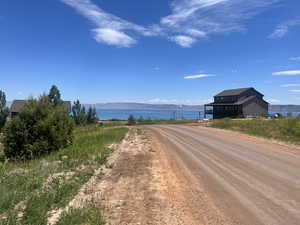 View of road featuring a water and mountain view