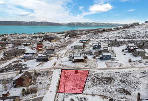 Snowy aerial view with a water and mountain view