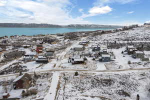 Snowy aerial view with a water and mountain view