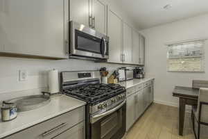 Kitchen featuring appliances with stainless steel finishes and light hardwood / wood-style flooring