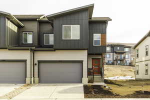 Townhome / multi-family property featuring a garage