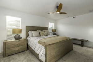 Carpeted bedroom with ceiling fan