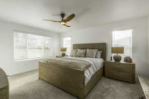 Bedroom with ceiling fan and light carpet