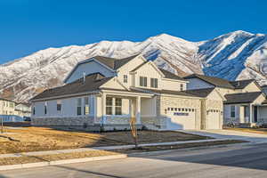 View of front of house with a mountain view and a garage