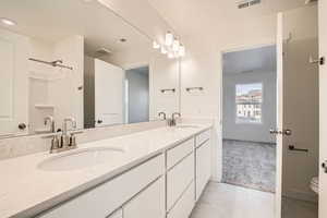 Bathroom featuring toilet, vanity, and tile  flooring