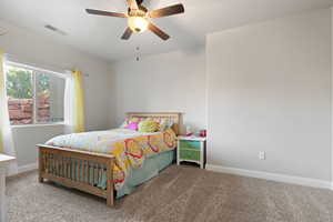 Carpeted bedroom with ceiling fan