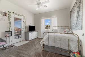 Bedroom featuring carpet, access to outside, and ceiling fan