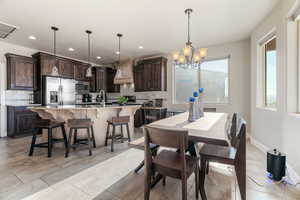 Dining room featuring sink and an inviting chandelier