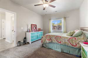 Carpeted bedroom featuring ceiling fan