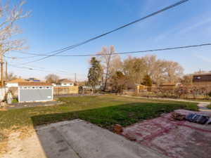 View of yard featuring a patio and an outdoor structure