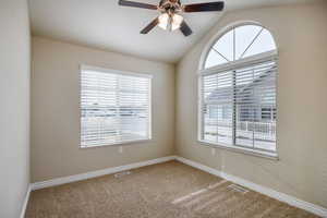 office/formal living room  with ceiling fan, plenty of natural light, carpet floors, and lofted ceiling