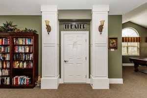 Carpeted foyer with vaulted ceiling and pool table