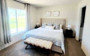 Bedroom featuring dark carpet