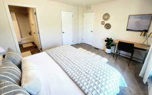 Bedroom featuring connected bathroom and carpet