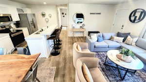 Living room with light wood-type flooring and sink