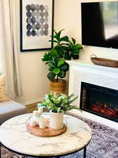 Interior space with hardwood / wood-style flooring and a high end fireplace