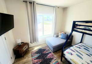 Bedroom with light hardwood / wood-style flooring