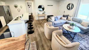 Living room with dark hardwood / wood-style flooring and sink