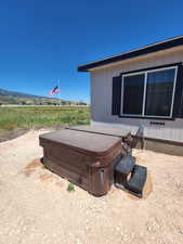 View of home's exterior with a hot tub