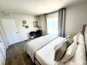 Bedroom featuring dark colored carpet