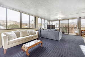 Interior space with a wealth of natural light and a textured ceiling