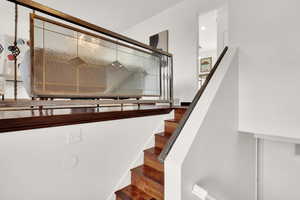 Staircase with hardwood / wood-style floors