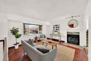 Living room featuring a fireplace and wood-type flooring