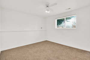 Unfurnished room with ceiling fan and carpet