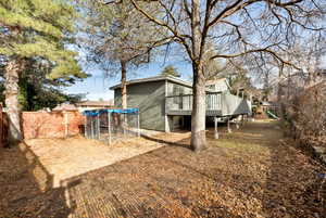 View of yard featuring a playground and a wooden deck