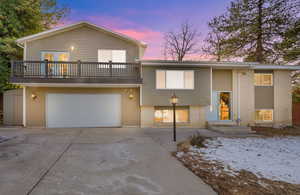 View of front facade with a balcony and a garage