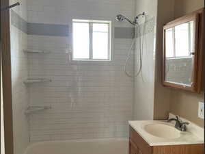 Full bathroom with a healthy amount of sunlight, toilet, and tiled shower / bath