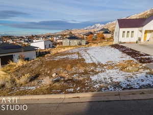 Snowy yard featuring a mountain view