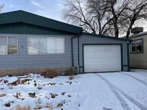 Exterior space with a garage and central AC unit