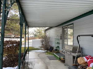 View of patio featuring a grill