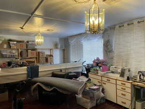 Interior space with dark hardwood / wood-style floors and a notable chandelier