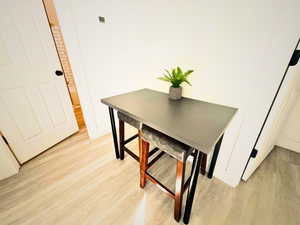 Dining space with light hardwood / wood-style flooring