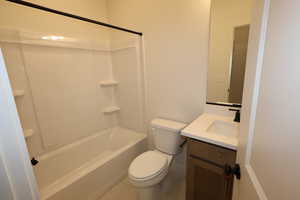 Full bathroom with vanity, toilet, and shower / bath combination