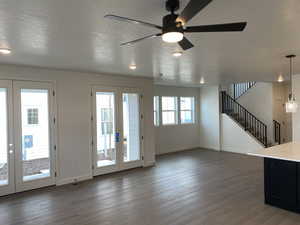 Dining room feauring laminate flooring, french doors, and a textured ceiling