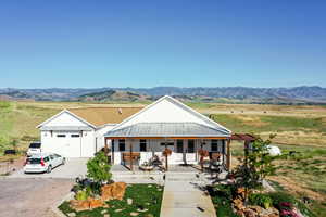 View of front facade featuring a mountain view and a porch