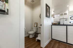 Bathroom featuring toilet and wood-type flooring